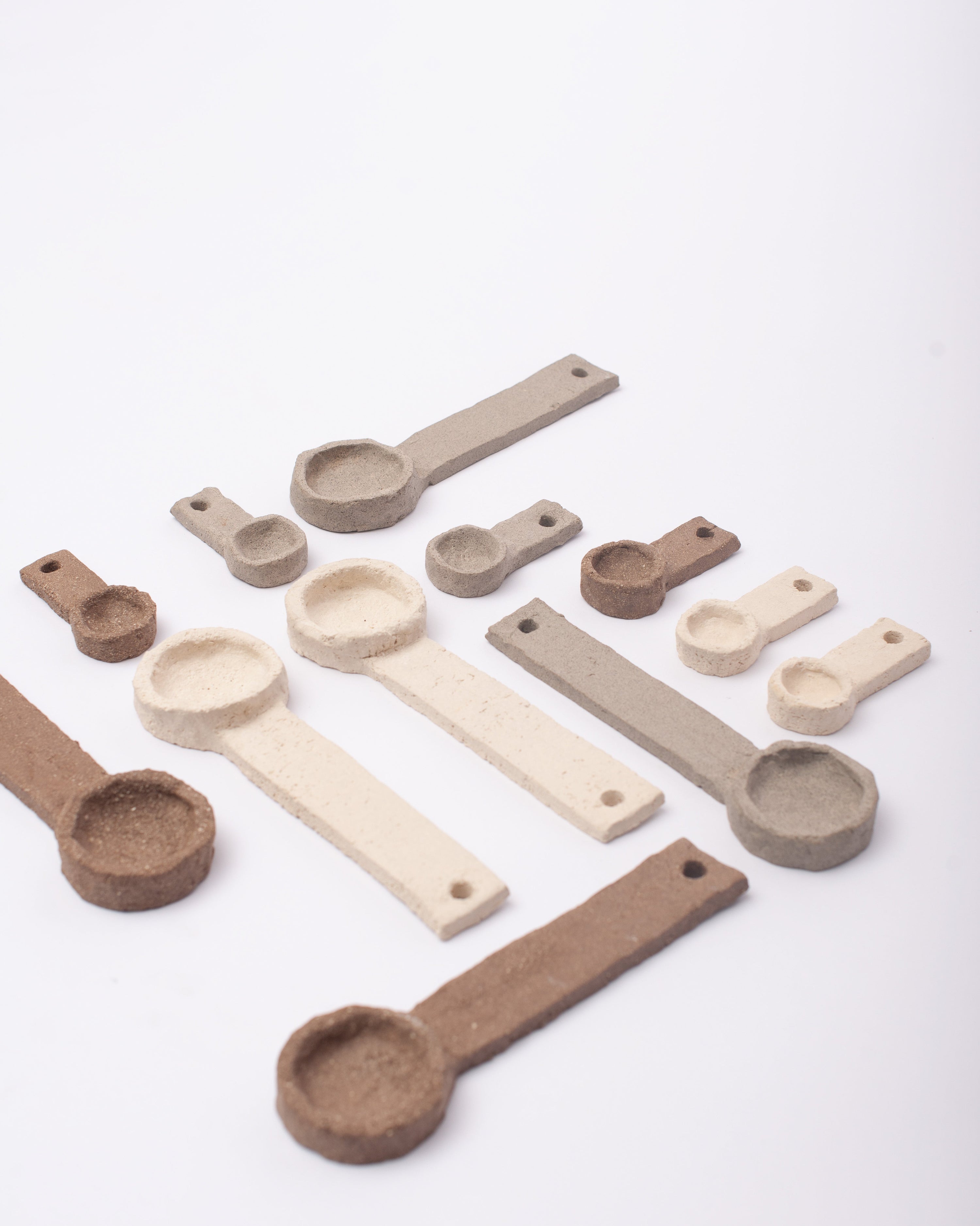 Set of ceramic spoons on a white background #1