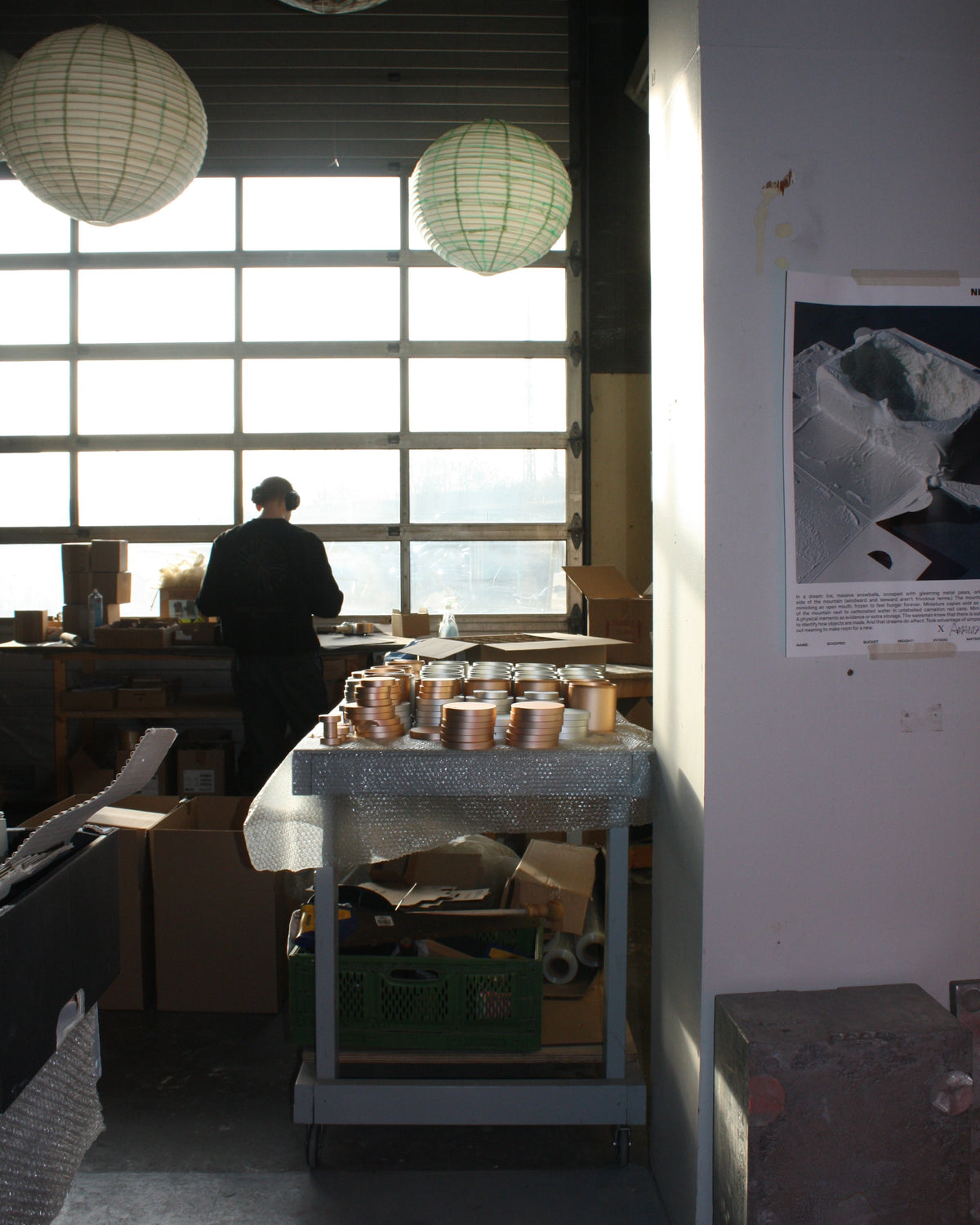 Parts of Chamber Series storage container by NIKO JUNE displayed in a bright workshop interior with wooden furniture and natural light.