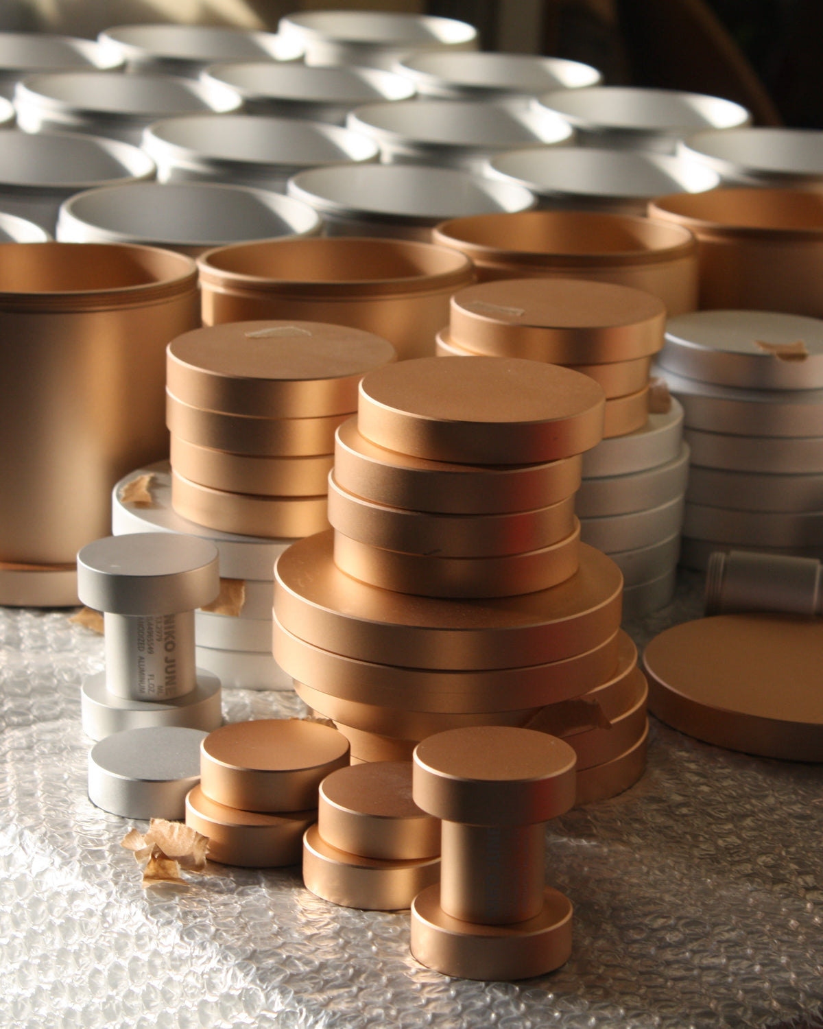 Chamber Series storage container by NIKO JUNE shown during the assembly process in a bright workshop interior with natural light.
