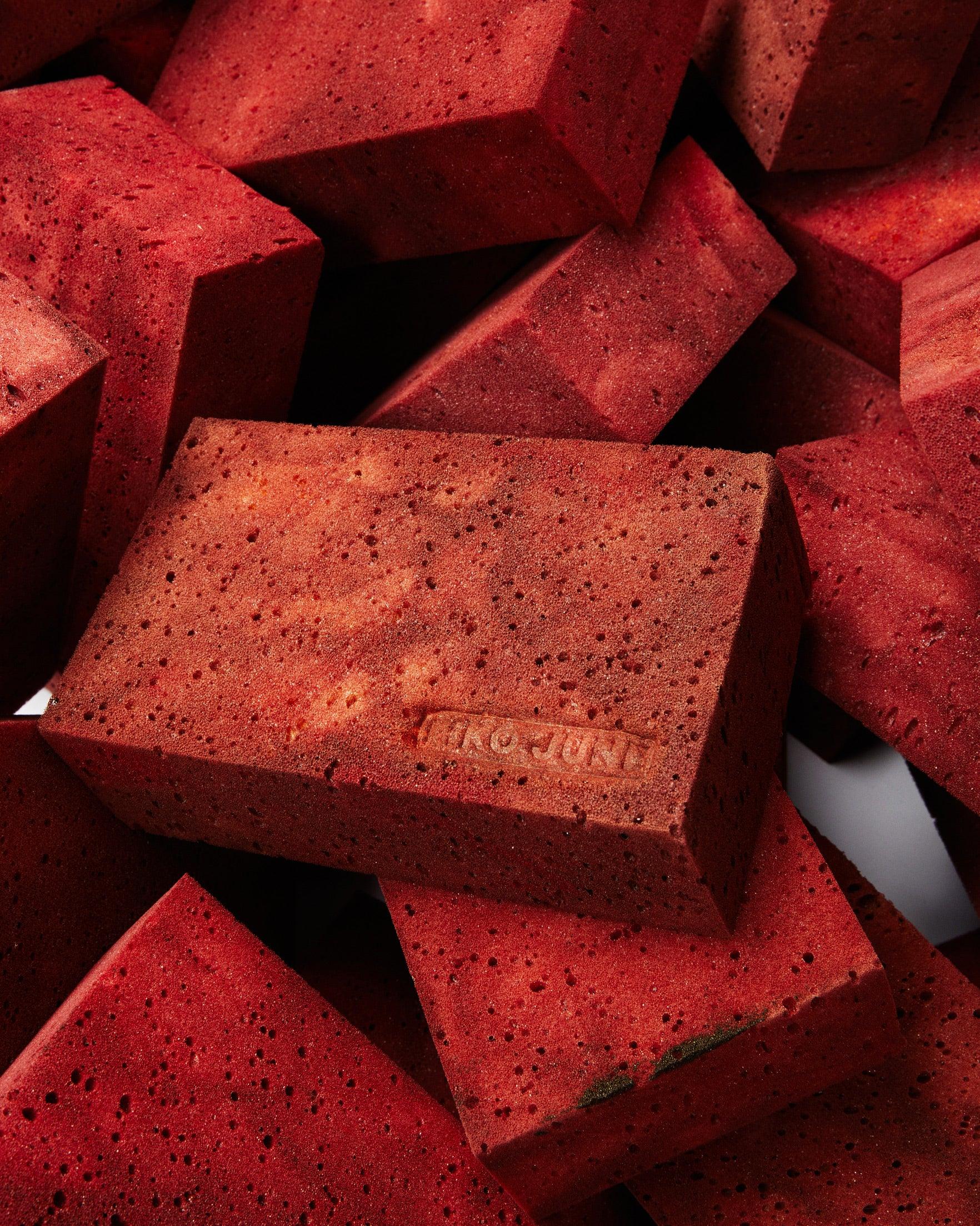 NIKO JUNE on red brick with bricks on top of each other