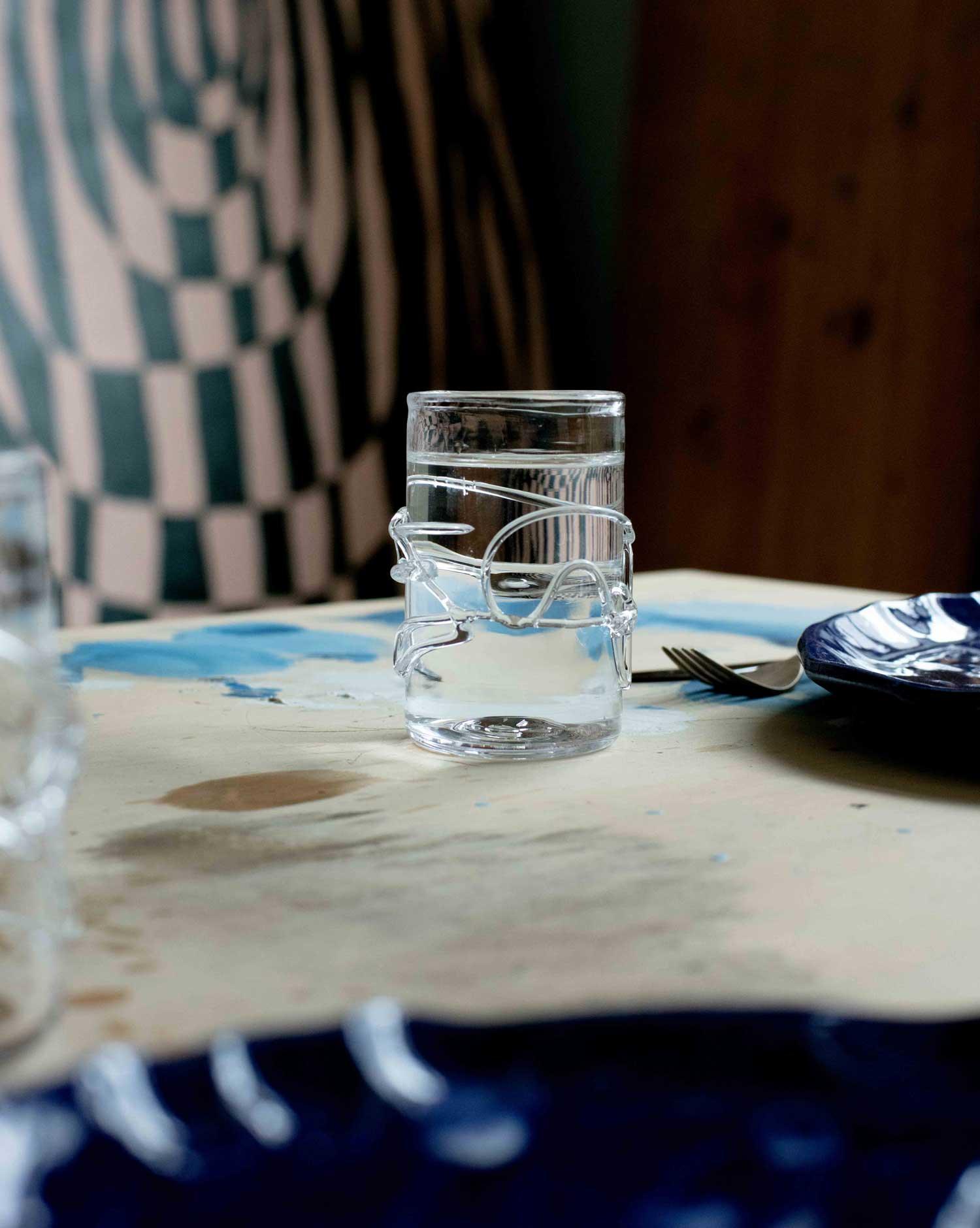 Hand blown glass with water melted glass details on a table